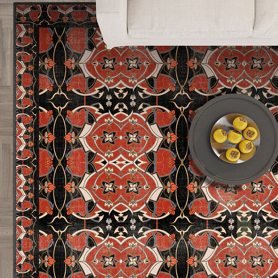 Decorative rug with intricate pattern on a wooden floor