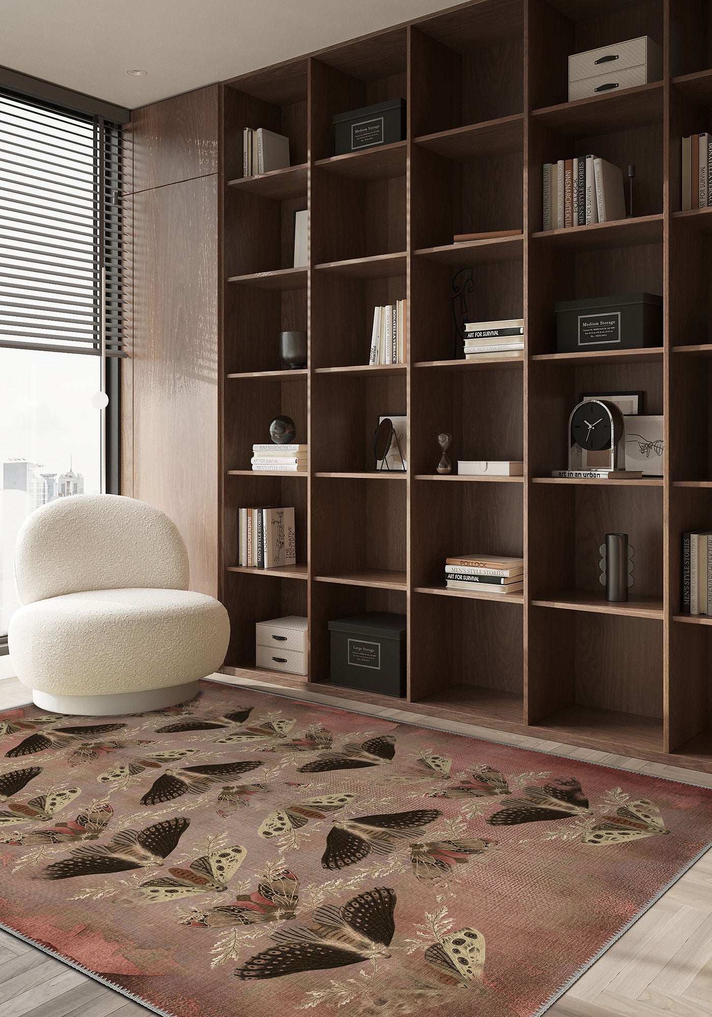 Modern living room with a large bookshelf, decorative rug, and armchair.