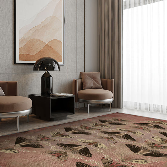 Modern living room with a patterned rug, chairs, and abstract art on the wall.