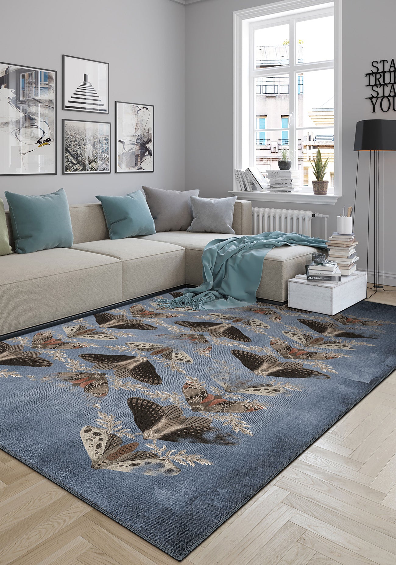 Living room with a blue butterfly-patterned rug on a wooden floor.