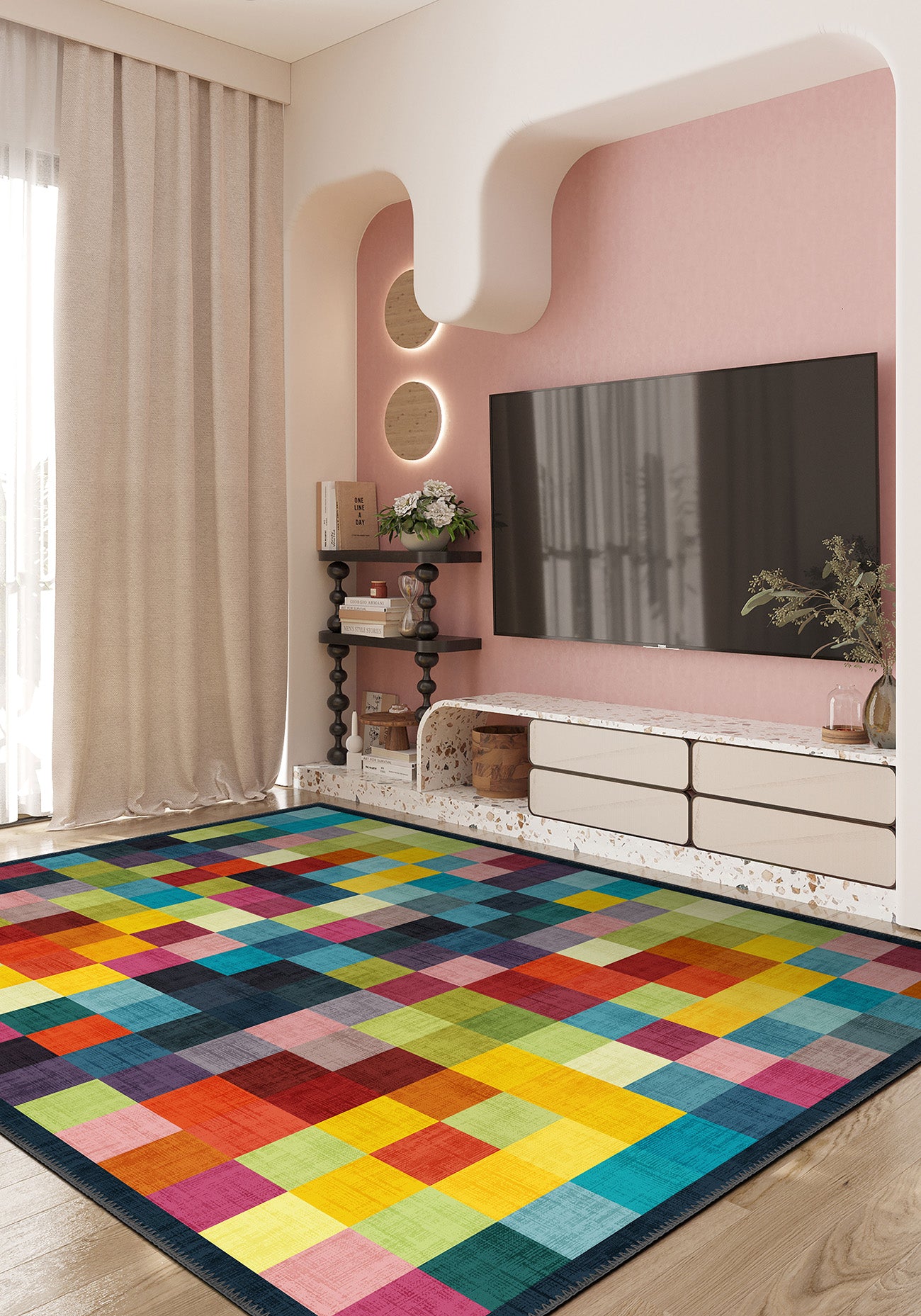 Colorful geometric rug in a living room with a pink wall and TV.