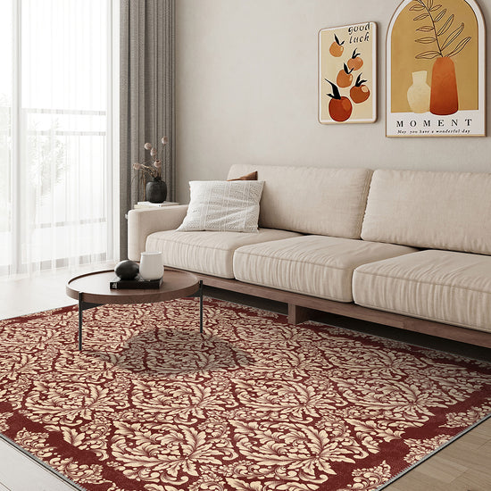 Living room with a beige sofa, patterned rug, and wall art.