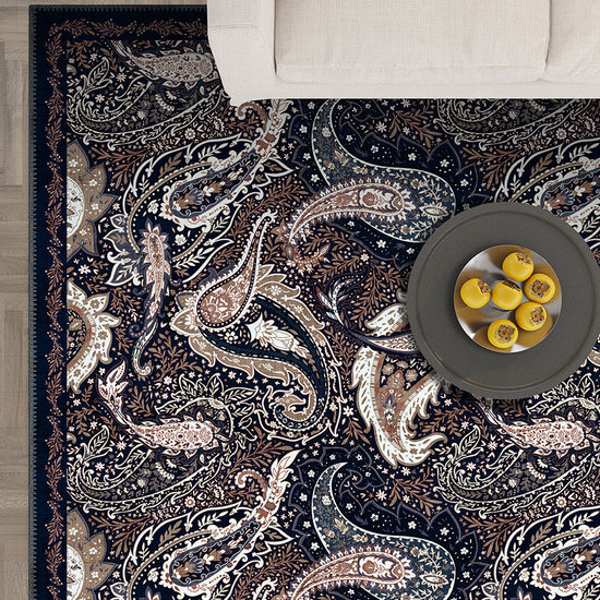 Paisley area rug in navy and brown colors.