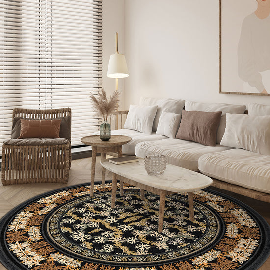 Black round rug with floral motifs.