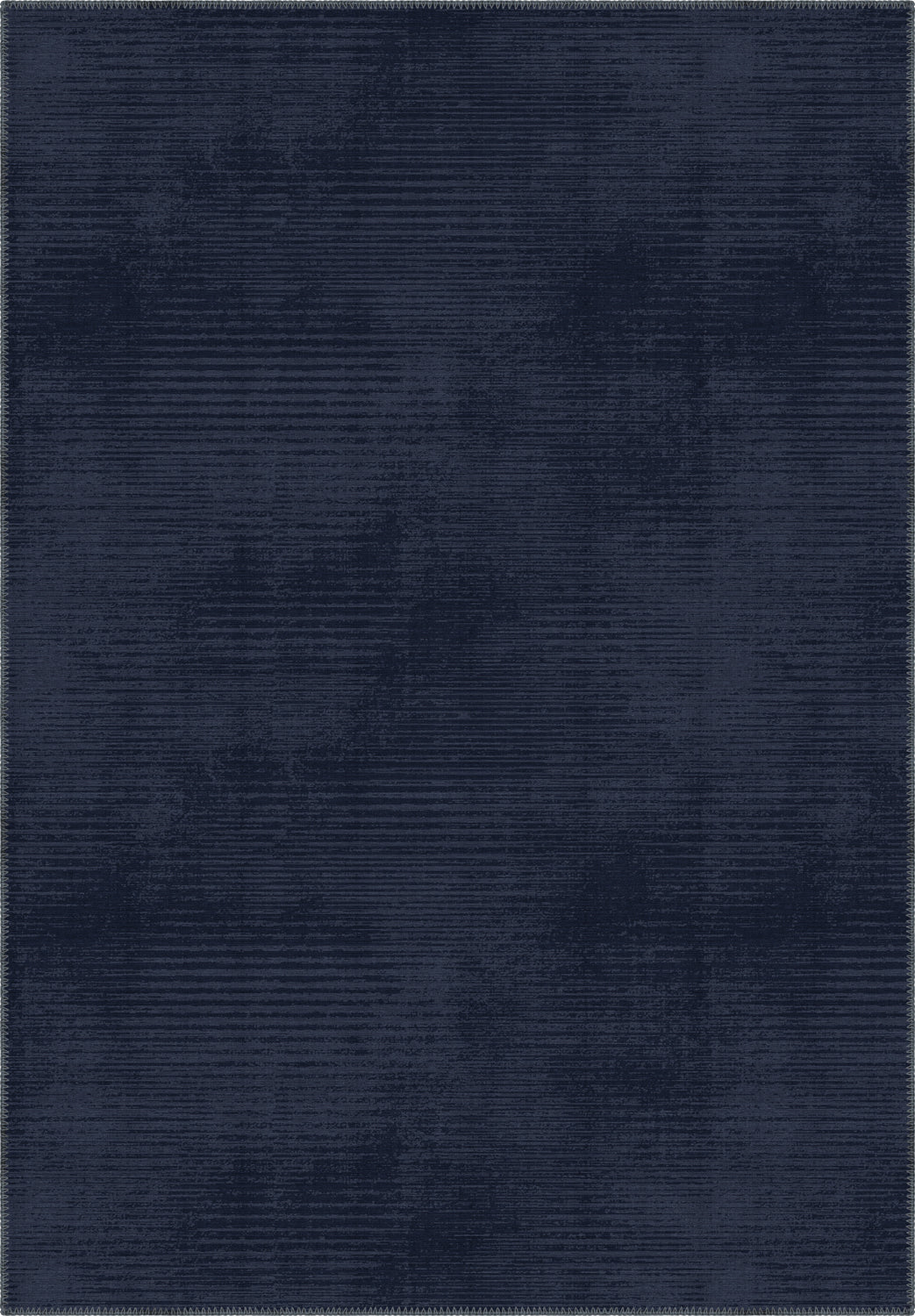 Navy blue rug with a subtle pattern in midnight blue tones.