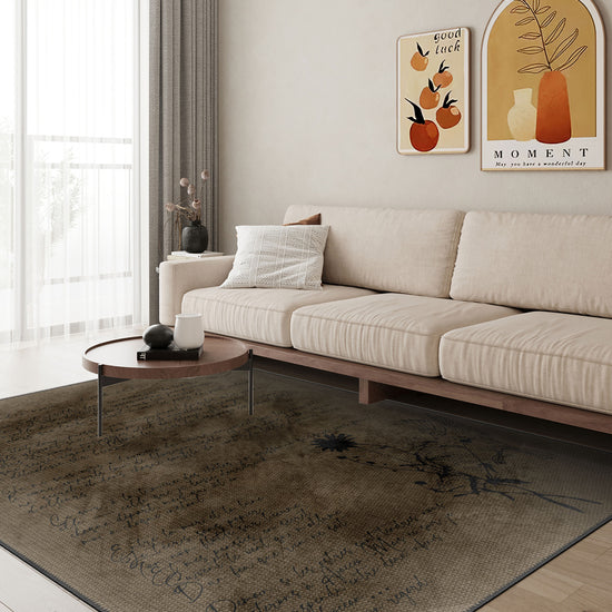 Modern living room with a beige sofa, coffee table, and decorative wall art.