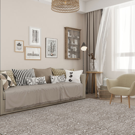 Living room with a patterned rug, sofa, and decorative elements.