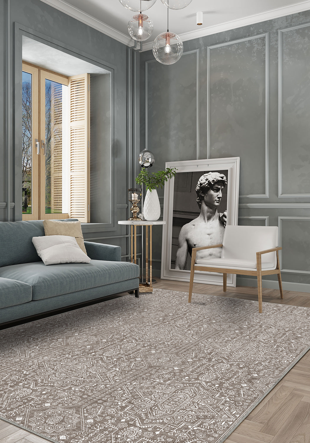 Modern living room with gray walls, a gray sofa, and a decorative rug.