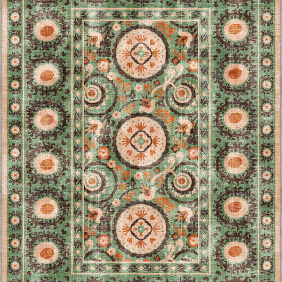 Green suzani rug with ethnic motifs.