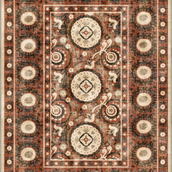Bohemian terracotta rug with suzani motifs.