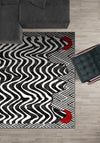 Black and white striped rug with red dots.